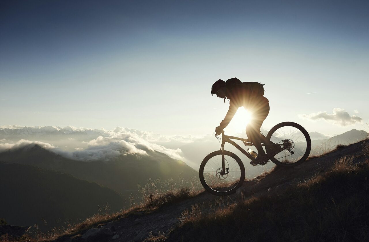mountain-biker-riding-downhill-valais-switzerland.jpg