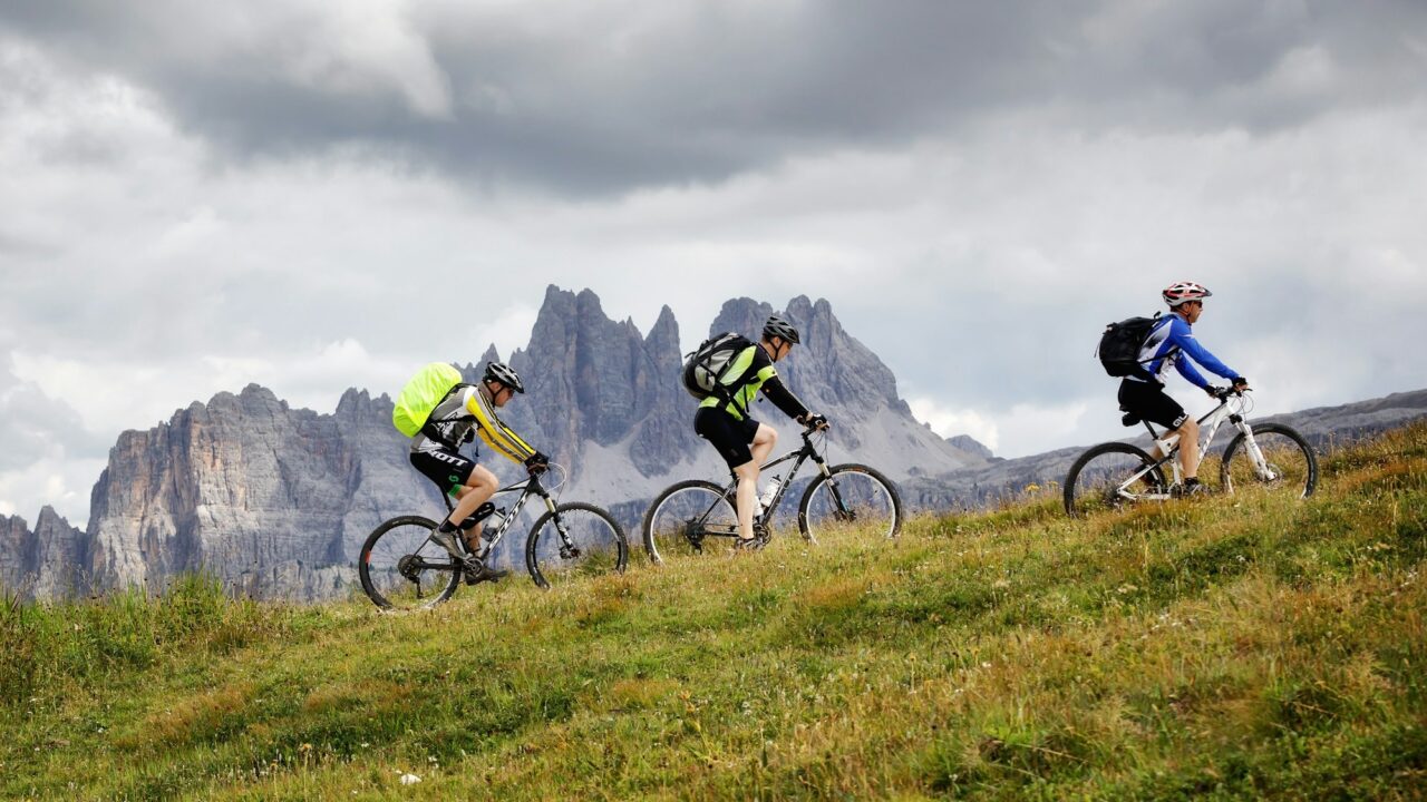 mountain-bikers-pedal-uphill-on-the-mountain-path.jpg